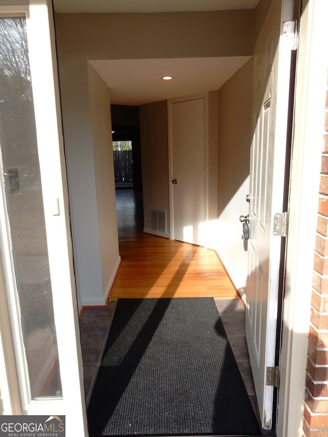 corridor featuring wood-type flooring