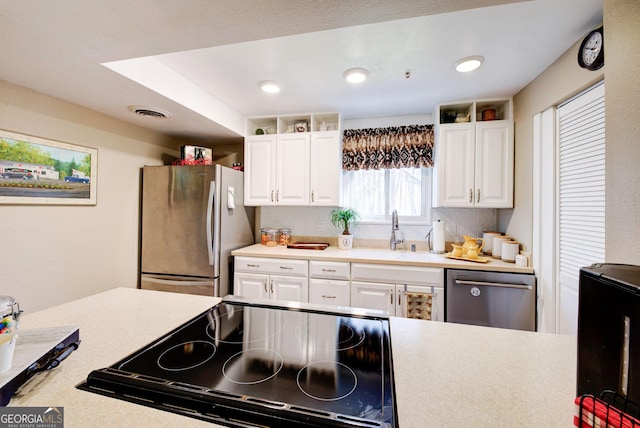 kitchen with white cabinetry, appliances with stainless steel finishes, and sink