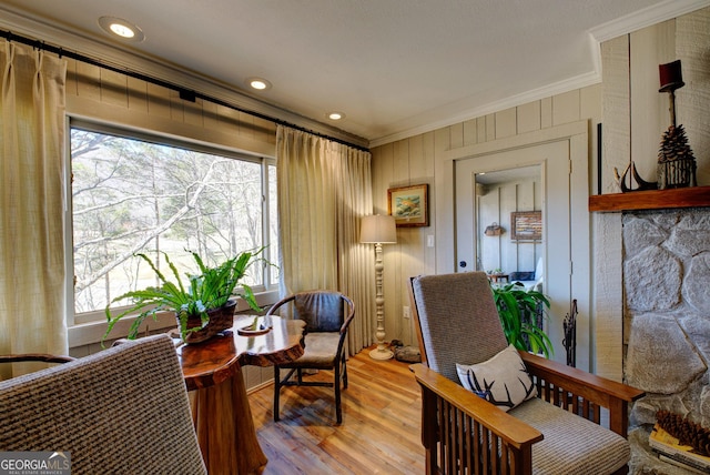 sitting room featuring light hardwood / wood-style flooring, crown molding, and plenty of natural light