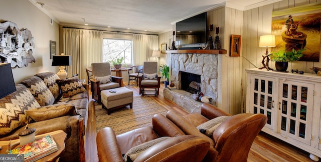 living room with crown molding, a fireplace, and hardwood / wood-style floors