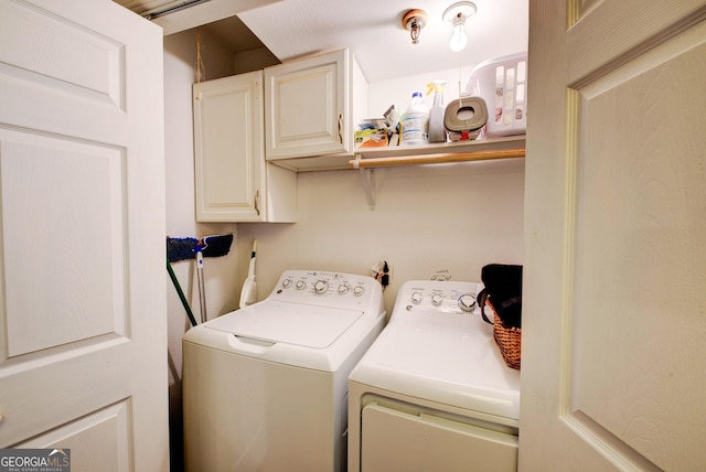 laundry room featuring cabinets and washing machine and dryer