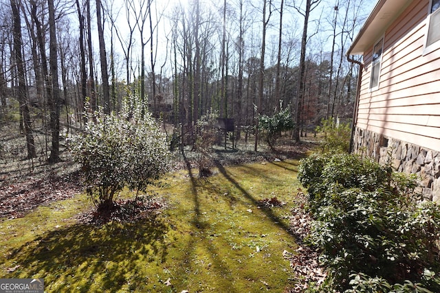 view of yard with a wooded view