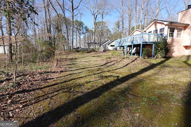 view of yard with a deck and stairs