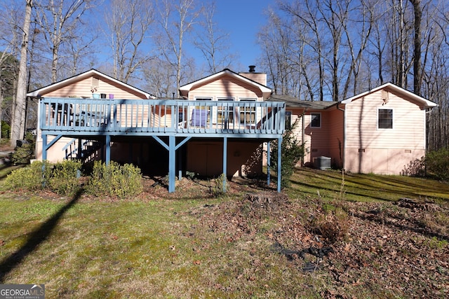 back of property with a deck, cooling unit, stairs, a yard, and a chimney