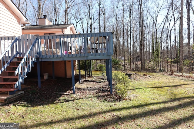 view of yard featuring a deck and stairway