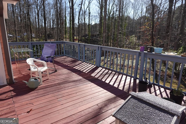 wooden terrace with a view of trees