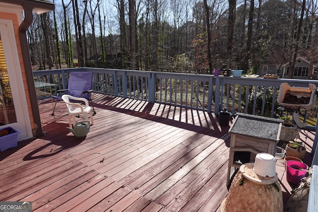 wooden deck featuring a view of trees