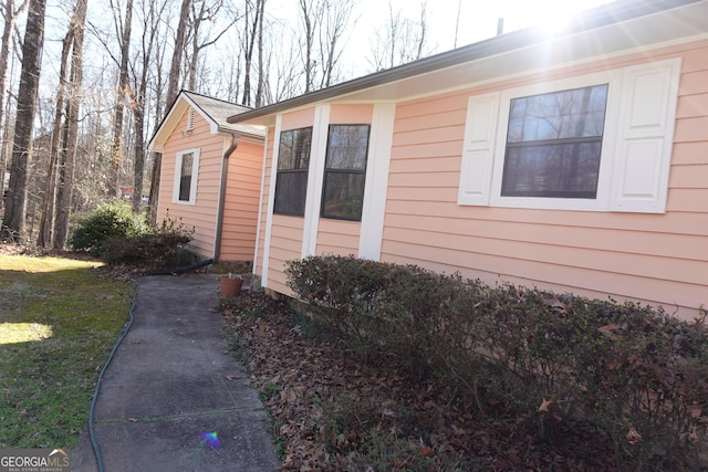 view of side of home with a lawn