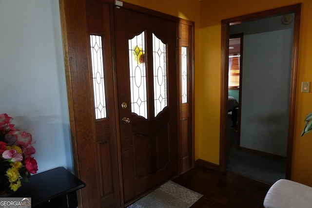 foyer entrance featuring baseboards and a healthy amount of sunlight