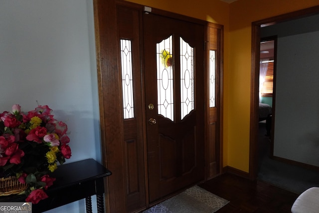 entrance foyer featuring dark wood-type flooring and baseboards