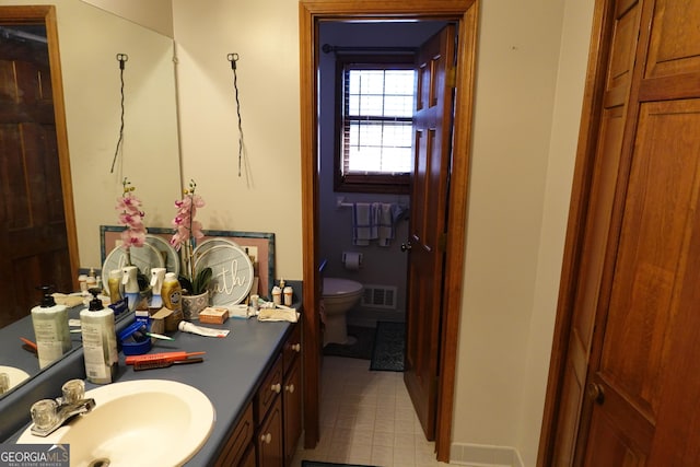 bathroom featuring toilet, visible vents, and vanity