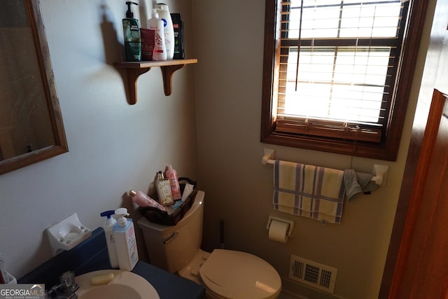 bathroom with toilet and visible vents