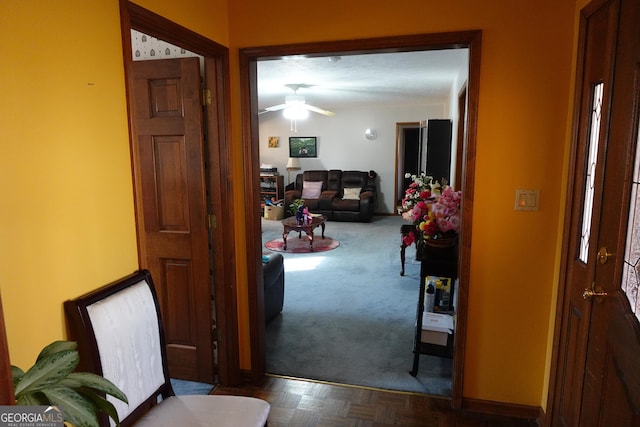 carpeted entrance foyer with ceiling fan