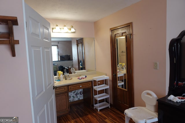 bathroom with a textured ceiling, wood finished floors, and vanity