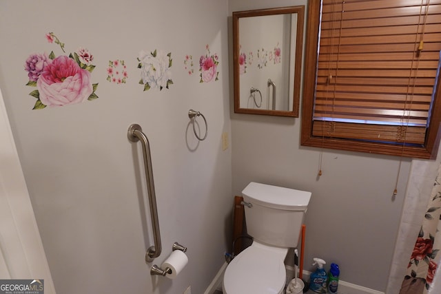 full bath with baseboards and toilet