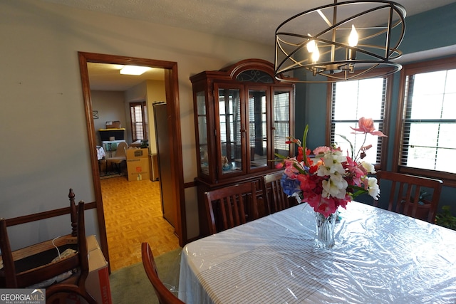 dining room with a notable chandelier and a textured ceiling