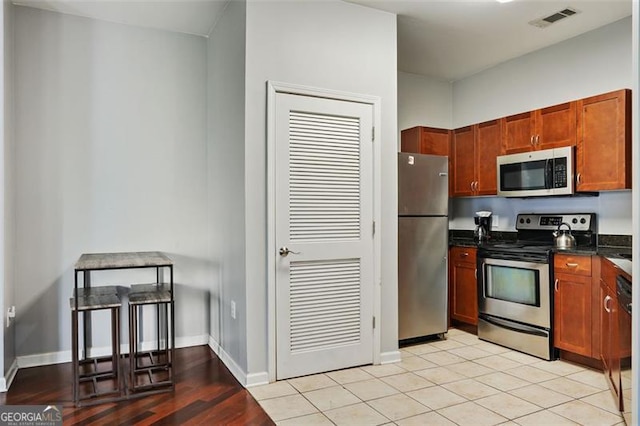 kitchen featuring light tile patterned floors and stainless steel appliances