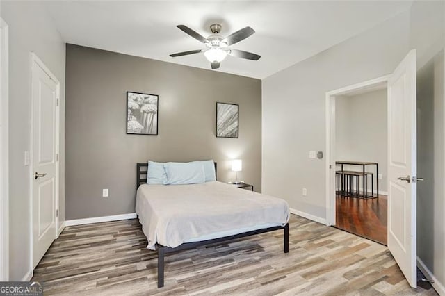 bedroom with ceiling fan and light hardwood / wood-style flooring