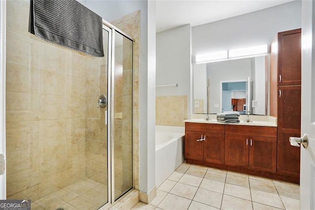 bathroom featuring independent shower and bath, vanity, and tile patterned flooring