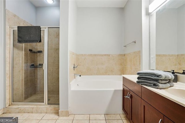 bathroom featuring tile patterned floors, plus walk in shower, and vanity