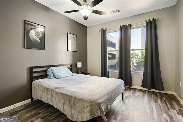 bedroom with dark wood-type flooring and ceiling fan