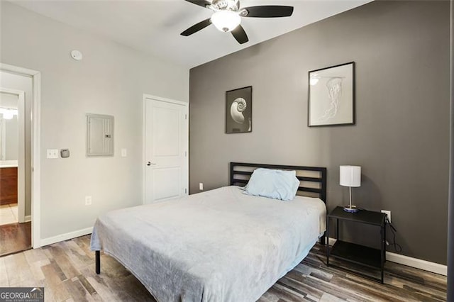 bedroom featuring wood-type flooring, electric panel, and ceiling fan