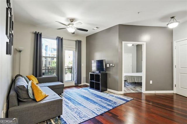 living room featuring ceiling fan and dark hardwood / wood-style flooring