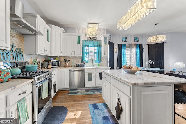 4901 Planters Walk, Douglasville, GA 30135 - kitchen featuring white cabinetry, stainless steel appliances, a center island, and wall chimney exhaust hood