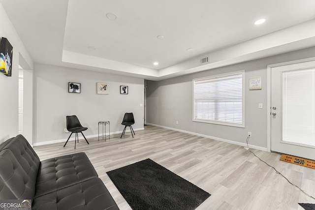 4901 Planters Walk, Douglasville, GA 30135 - living area with a tray ceiling and light hardwood / wood-style flooring