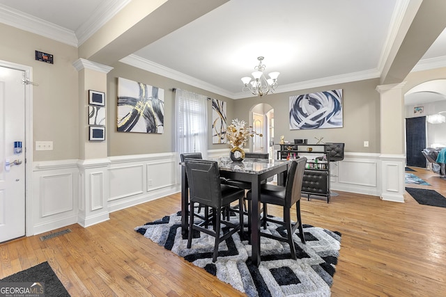 4901 Planters Walk, Douglasville, GA 30135 - dining room featuring crown molding, decorative columns, a chandelier, and light wood-type flooring