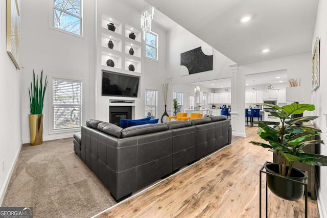 living room with a high ceiling and light wood-type flooring