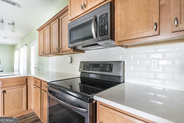 kitchen with tasteful backsplash, sink, and stainless steel electric range oven