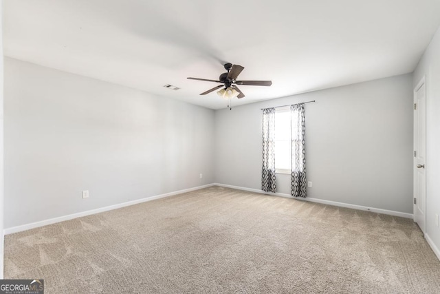 spare room with ceiling fan and carpet flooring