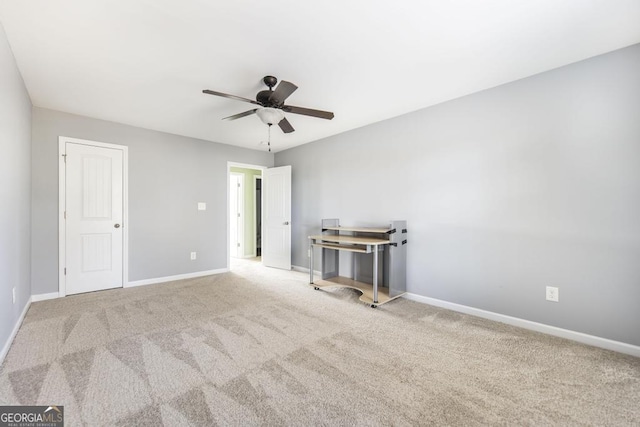 carpeted empty room featuring ceiling fan