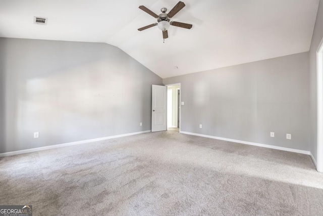 spare room with vaulted ceiling, ceiling fan, and carpet