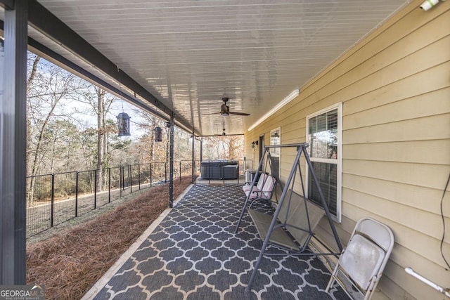 view of patio with central AC, ceiling fan, and a jacuzzi