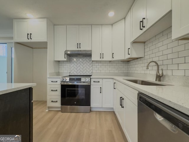 kitchen featuring tasteful backsplash, range with electric cooktop, a center island, and white cabinets