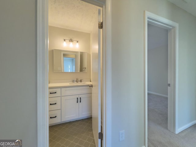 unfurnished living room with built in features, a fireplace, carpet, and a textured ceiling