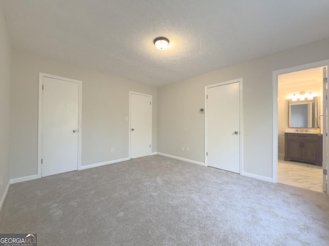 carpeted empty room featuring a textured ceiling