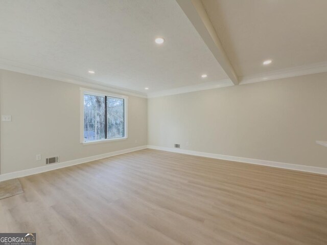 unfurnished living room featuring ornamental molding, a textured ceiling, and light wood-type flooring