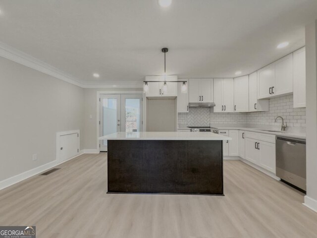 kitchen featuring stainless steel electric range, tasteful backsplash, white cabinets, crown molding, and french doors