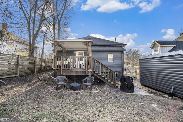 back of house with a wooden deck