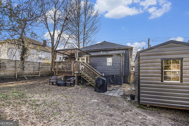 rear view of house featuring an outdoor structure