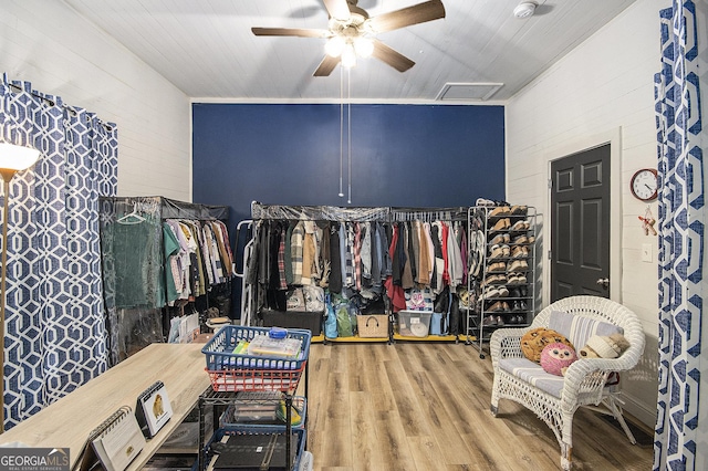 spacious closet with hardwood / wood-style floors and ceiling fan