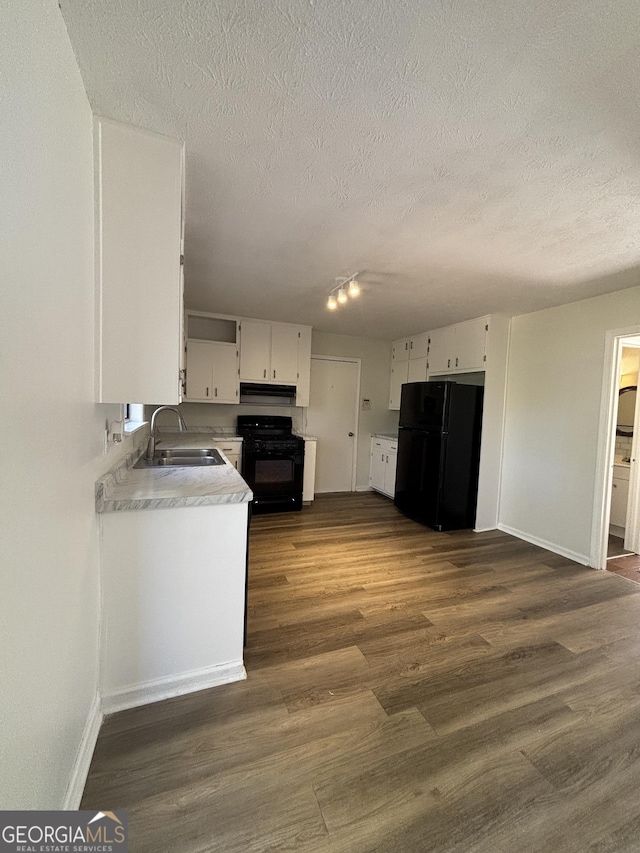 kitchen featuring sink, black appliances, a textured ceiling, dark hardwood / wood-style floors, and white cabinets