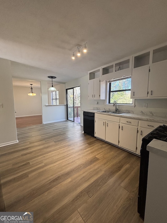 kitchen with pendant lighting, dishwasher, sink, and white cabinets