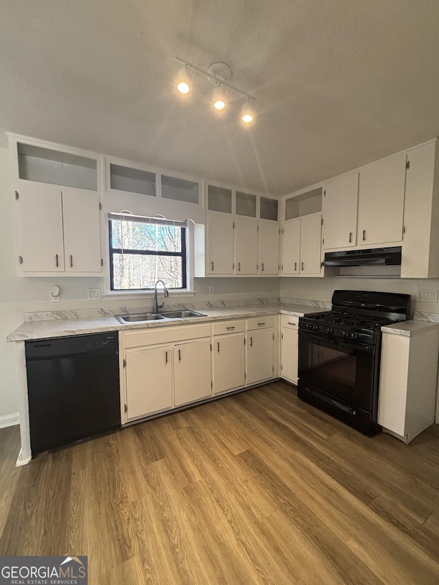 kitchen with sink, black appliances, a textured ceiling, light hardwood / wood-style floors, and white cabinets