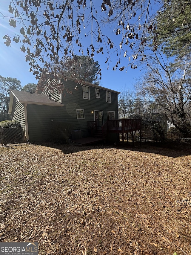 back of property featuring a deck