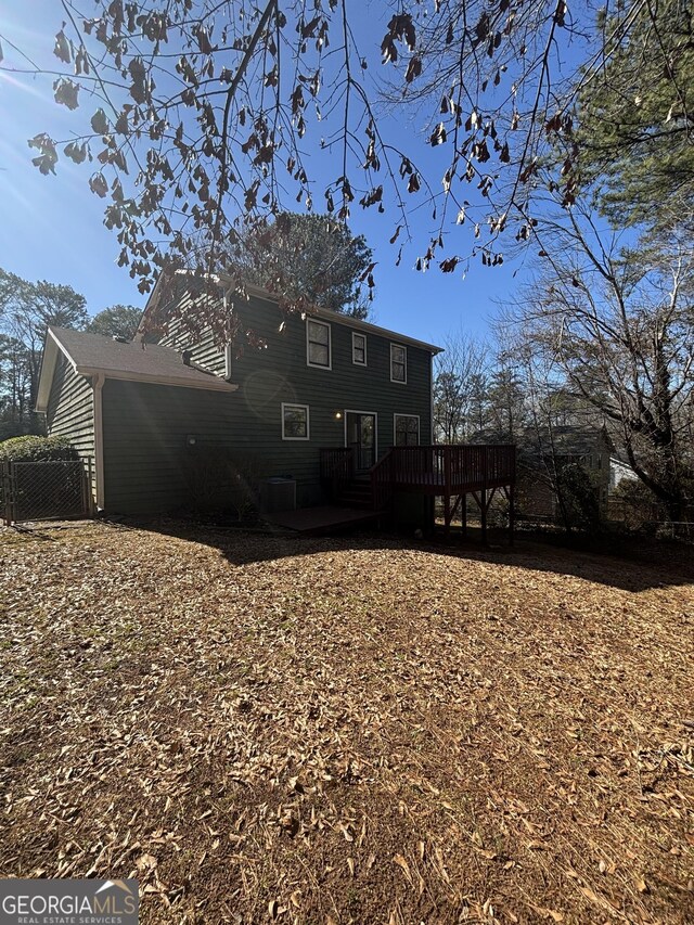 rear view of property with a wooden deck