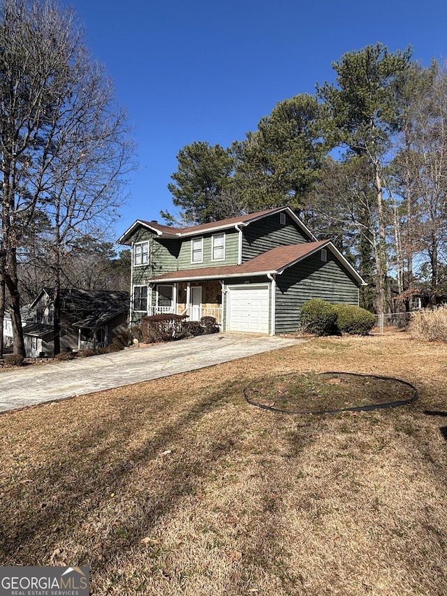 view of front of home featuring a porch, a garage, and a front lawn